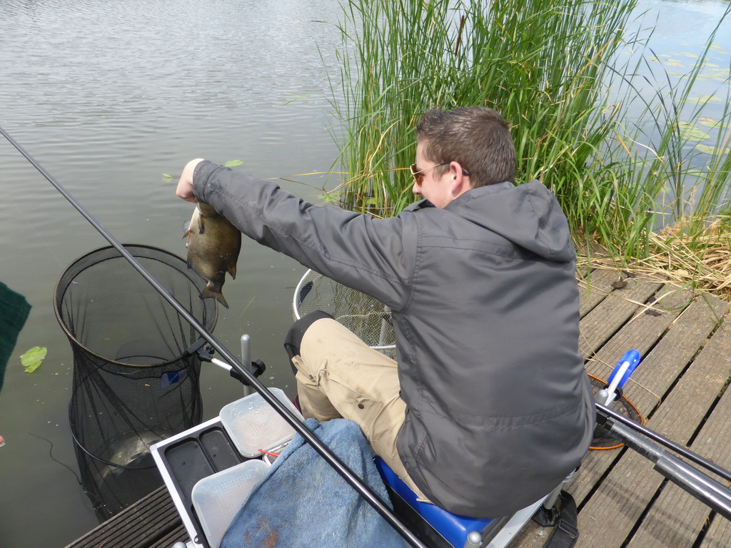 Fisherman with fish at the Molenkade Nederwaard street