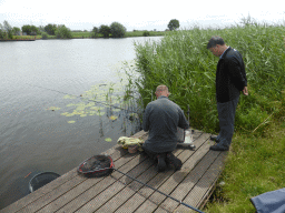 Miaomiao`s father with a fisherman at the Molenkade Nederwaard street