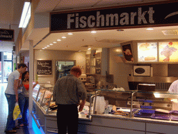 Tim and Miaomiao in the fish department in a supermarket