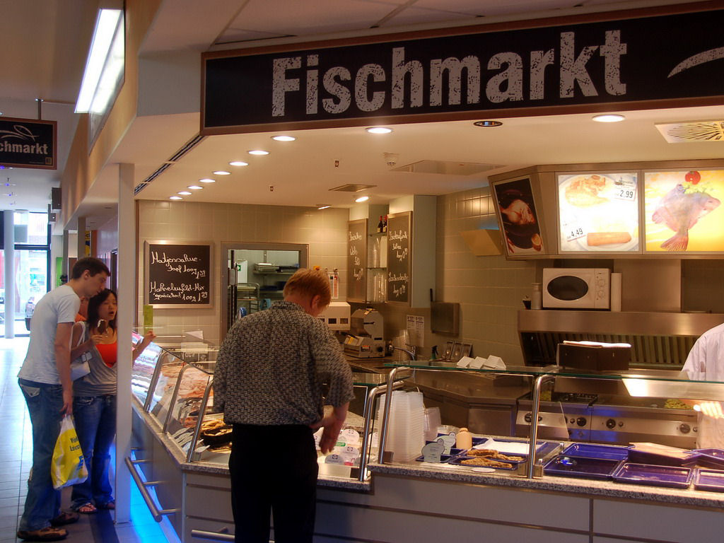 Tim and Miaomiao in the fish department in a supermarket