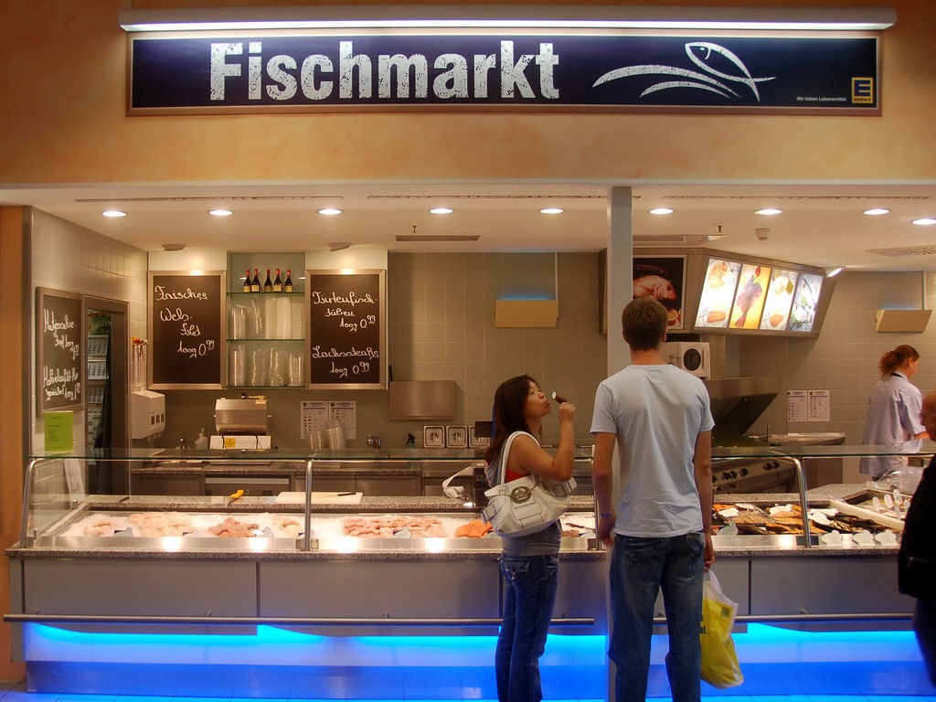 Tim and Miaomiao in the fish department in a supermarket