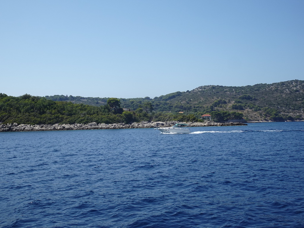 Boat in front of the Rt. Ratac point at the north side of the Kolocep island, viewed from the Elaphiti Islands tour boat