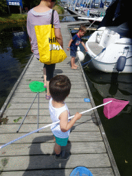 Miaomiao, Max and a friend catching crabs on a pier at Camping and Villa Park De Paardekreek
