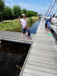 Miaomiao and friends catching crabs on a pier at Camping and Villa Park De Paardekreek