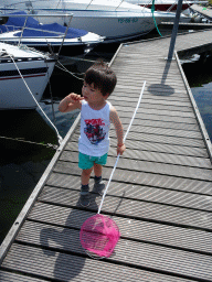 Max catching crabs on a pier at Camping and Villa Park De Paardekreek