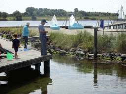 Miaomiao`s parents and a friend catching crabs on a pier at Camping and Villa Park De Paardekreek