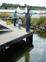 Max and Miaomiao`s parents catching crabs on a pier at Camping and Villa Park De Paardekreek