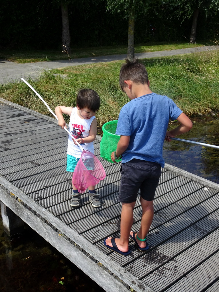 Max and a friend catching crabs on a pier at Camping and Villa Park De Paardekreek