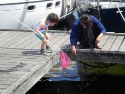 Max and a friend catching crabs on a pier at Camping and Villa Park De Paardekreek