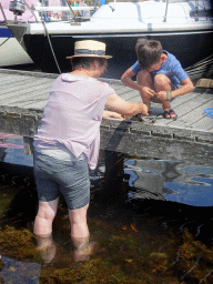 Miaomiao and a friend catching crabs at Camping and Villa Park De Paardekreek