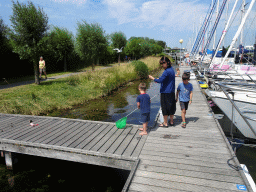 Our friends catching crabs on a pier at Camping and Villa Park De Paardekreek