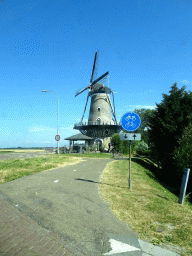The Korenbloem windmill, viewed from the car on the Hoofdstraat street