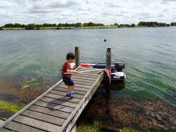 Max catching crabs on a pier at Camping and Villa Park De Paardekreek