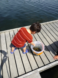 Max catching crabs on a pier at Camping and Villa Park De Paardekreek