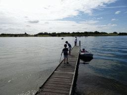 Our friends catching crabs on a pier at Camping and Villa Park De Paardekreek