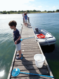 Our friends catching crabs on a pier at Camping and Villa Park De Paardekreek