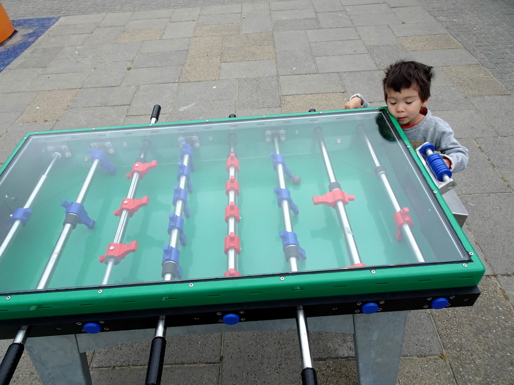 Max playing table football at the playground at Camping and Villa Park De Paardekreek