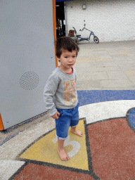 Max playing a dancing game at the playground at Camping and Villa Park De Paardekreek