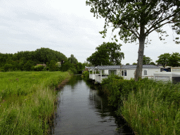 Holiday homes and stream at Camping and Villa Park De Paardekreek, viewed from a bridge
