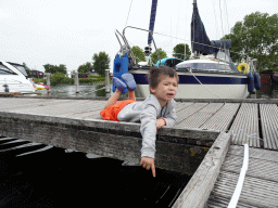 Max catching crabs on a pier at Camping and Villa Park De Paardekreek