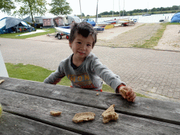 Max eating bread at the terrace of our holiday home at Camping and Villa Park De Paardekreek