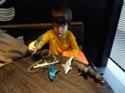 Max playing with dinosaur and animal toys at the Departure Hall of Eindhoven Airport