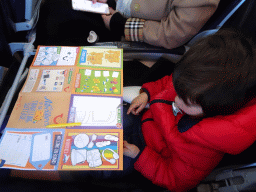 Max doing puzzles in the airplane from Eindhoven