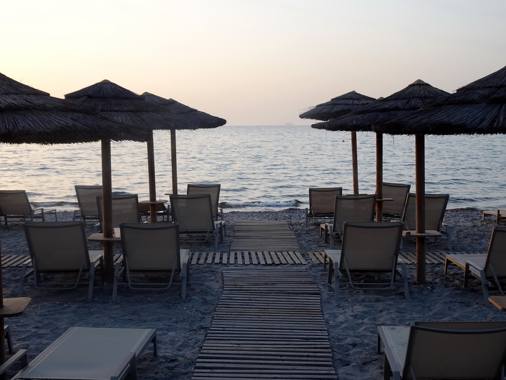 Sun loungers and parasols at the beach of the Blue Lagoon Resort, at sunset