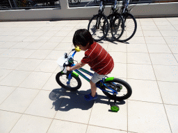 Max on a bike in front of the SteveBikes shop at the crossing of the Olympias and Dimitras streets