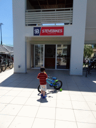 Max with a bike in front of the SteveBikes shop at the crossing of the Olympias and Dimitras streets