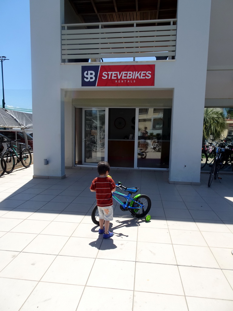 Max with a bike in front of the SteveBikes shop at the crossing of the Olympias and Dimitras streets