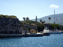 Boats at the east side of the Limenas Ko harbour and tower of the Gazi Hassan Pasha Mosque, viewed from the northwest side