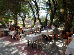 Terrace of restaurants at the Nafklirou street, with a view on the Archaeological Site of the Harbour Quarter-Agora