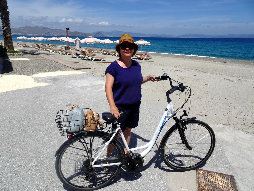 Miaomiao with the bike at the north side of Lambi Beach, with a view on the Bodrum Peninsula in Turkey