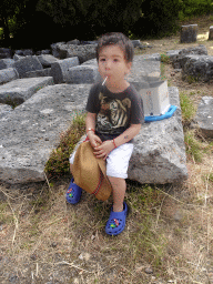 Max with a lollipop and ruins at the lower level of the Asclepeion