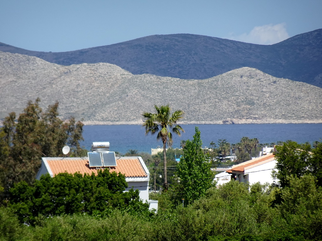 Trees, houses, the Aegean Sea and the island of Pserimos, viewed from the Triantafyllopoulos Winery