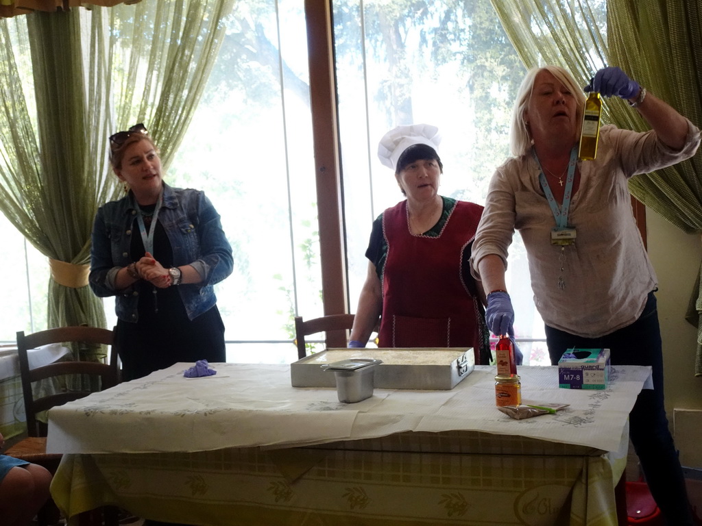 Tour guides showing the ingredients of Moussaka at the Taverna Olympia restaurant at the town of Zia