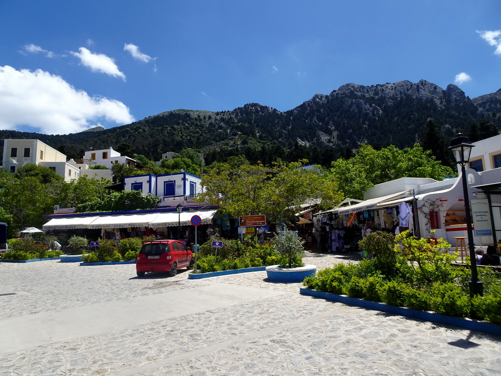 Souvenir shops and restaurants at the main street of the town of Zia, and Mount Dikeos