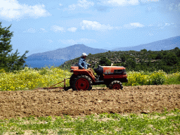 Tractor on the farmland near the Melissa Honey Farm at the east side of the town of Kefalos, and the islands of Giali and Nisiros