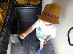 Max lighting a candle in a small chapel on the west side of the Church of Agia Paraskevi