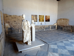 Statue, busts and photographs at the Exedra at the Casa Romana museum