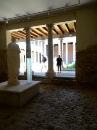 Statue at the Casa Romana museum, with a view on the Large Peristyle at the Casa Romana museum