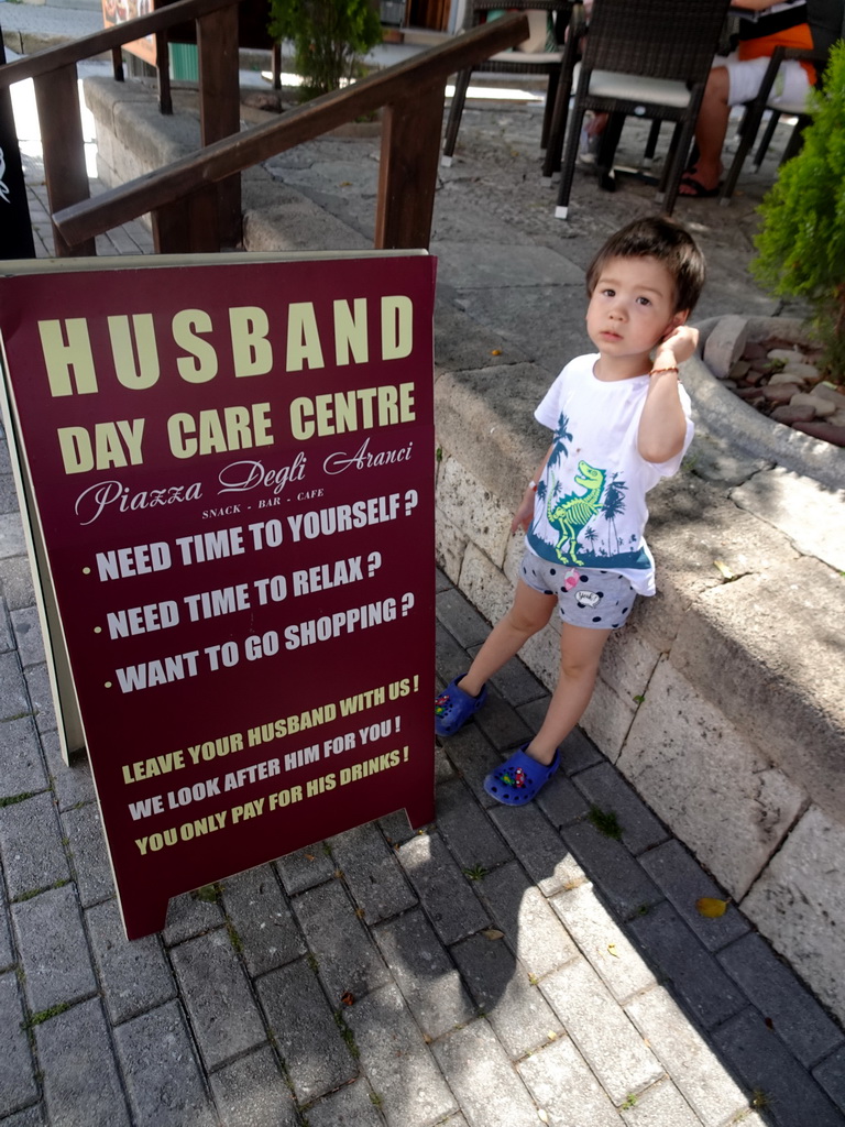 Max with a sign at the Platía Agias Paraskevis square