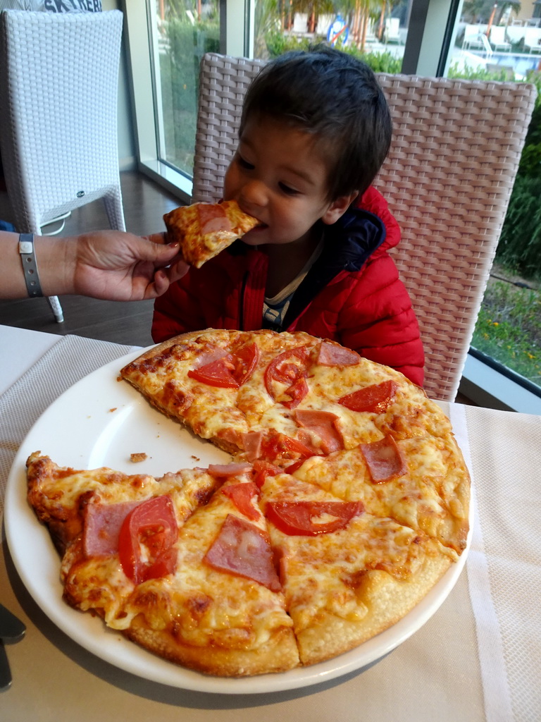 Max eating pizza at the Karavi Restaurant at the Blue Lagoon Resort