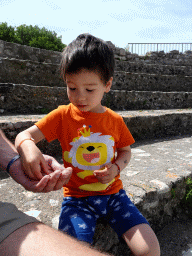 Max playing with coins at the Roman Odeum