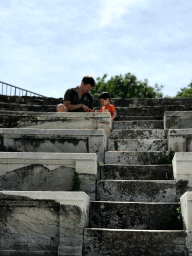 Tim and Max playing with coins at the Roman Odeum