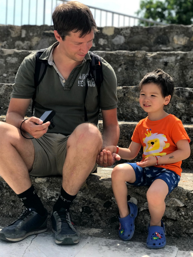 Tim and Max playing with coins at the Roman Odeum