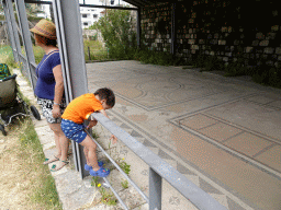 Miaomiao and Max at the mosaic at the north end of the West Archaeological Site