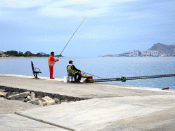 Fishermen at Kos Port, with a view on the Aegean Sea and the Bodrum Peninsula in Turkey
