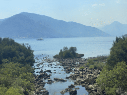 Inlet to the Reka Ljuta lake and boats at the Bay of Kotor, viewed from the tour bus on the E65 road at the town of Ljuta